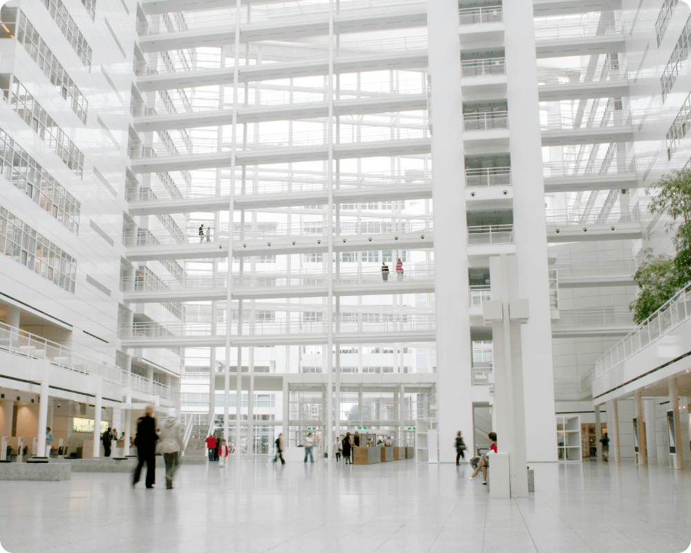 Spacious, light-filled atrium in a commercial office, representing workplace design for occupancy intelligence and portfolio evaluation.