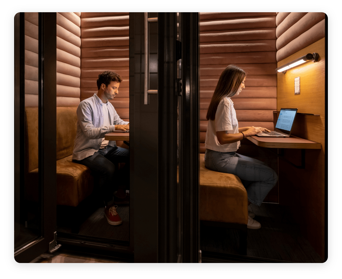 Two employees working in private focus booths, showcasing how occupancy intelligence enhances workplace space design for productivity and concentration.