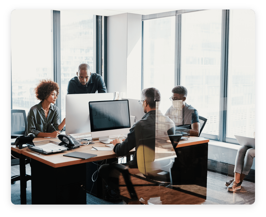 Team collaborating in a modern office, demonstrating how workplace environments can benefit from occupancy intelligence to optimize space usage.