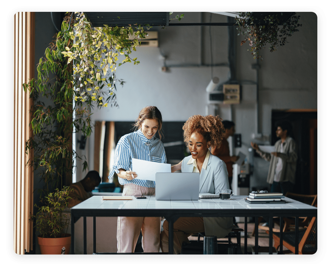 Team members reviewing documents in a flexible workplace, highlighting the role of occupancy intelligence in enhancing space utilization and productivity.